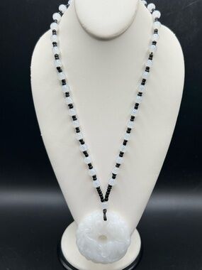 Asian style glass necklace with carved pendant